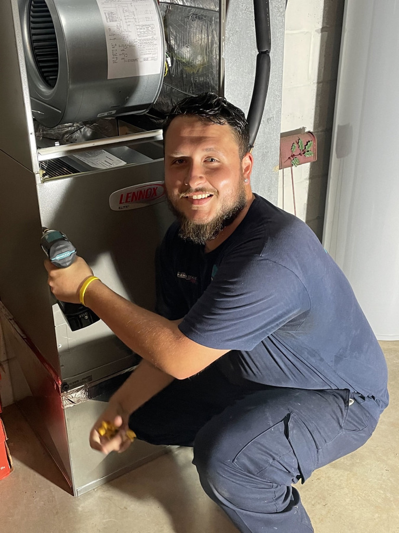 A Comfort Zone HVAC technician servicing a system